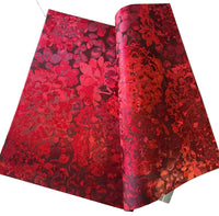 Red floral patterned fabric on a white surface